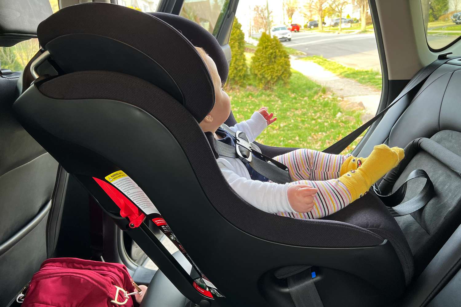 Child sitting in the Clek Foonf car seat