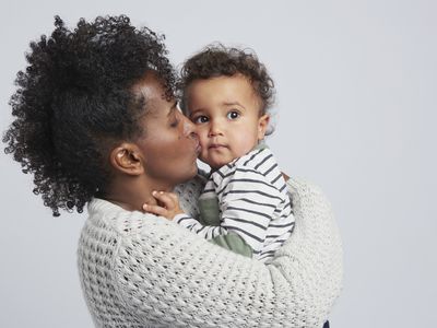 Mother kissing her toddler on the cheek