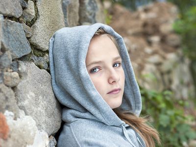 sad young girl in hoodie